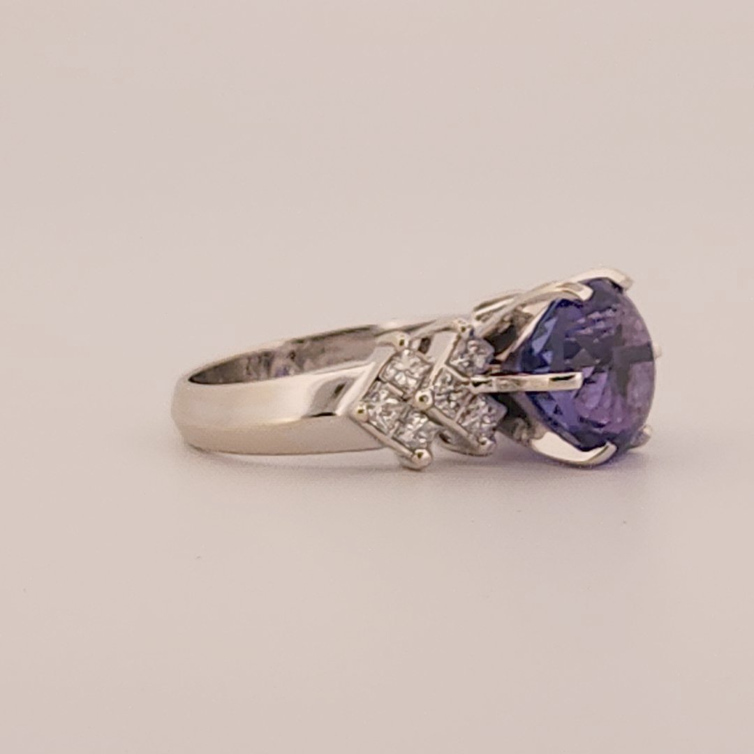 Natural Round Modified Brilliant Cut, Bluish Violet Tanzanite (5.25 CT - 10.20 mm) with 12 Natural Princess cut 3x3 mm Square Diamonds (1.92 CTW) Ring 14K White Gold. GIA Certified (2231466864).