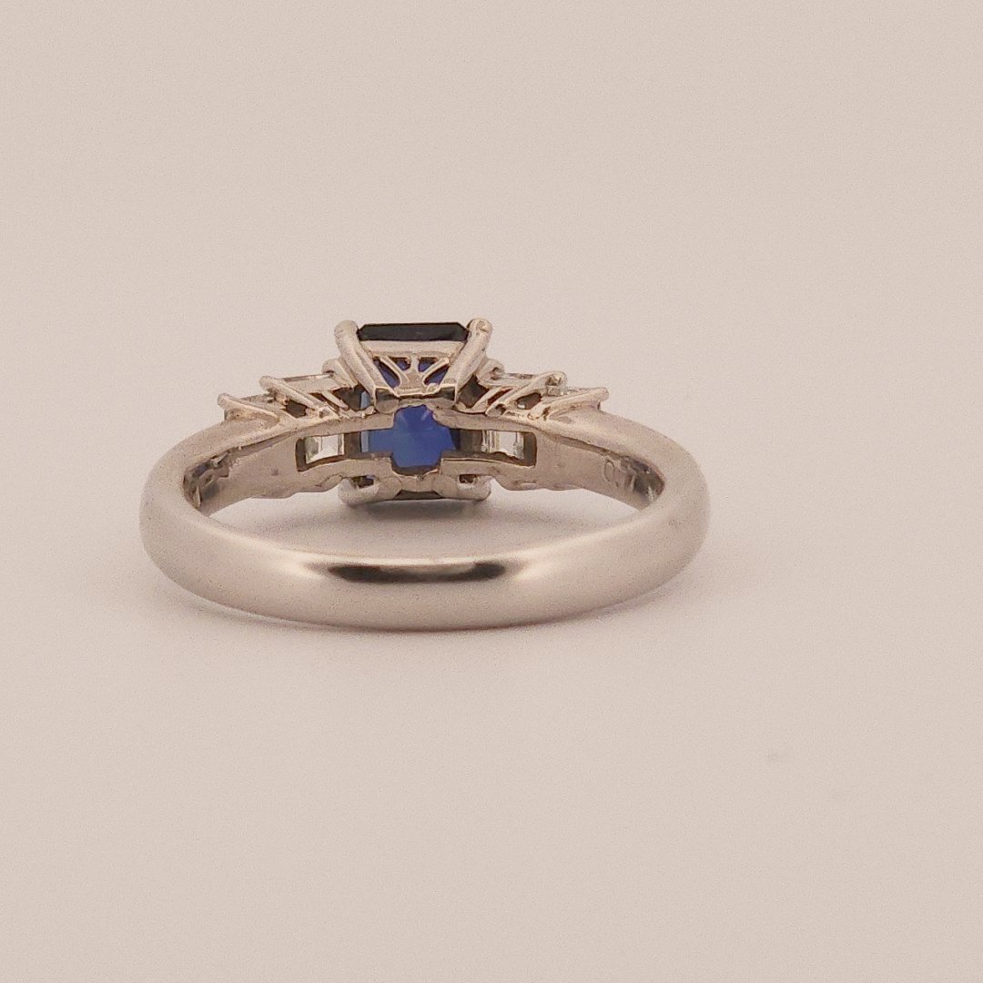 Emerald Step-Cut, AAA Natural Blue Sapphire (1.15CT, 7x5mm), Mounted on Platinum 900 Ring with Natural Diamonds (0.77 CTW, E/F VS1/VS2). Size 7.25